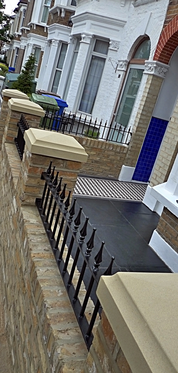 classic-london-front-garden-paving-mosaic-path-new-brick-wall-stone-pier-caps-and-metal-gate-and-rails-london.JPG