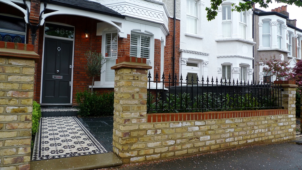 Yorkstone entrance stone victorian mosaic tile path yellow brick garden wall with metal rail slate paving planting London