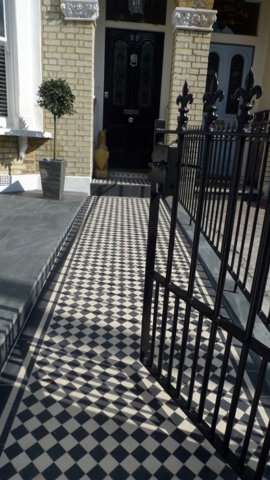 black and white victorian mosaic tile path with line border London