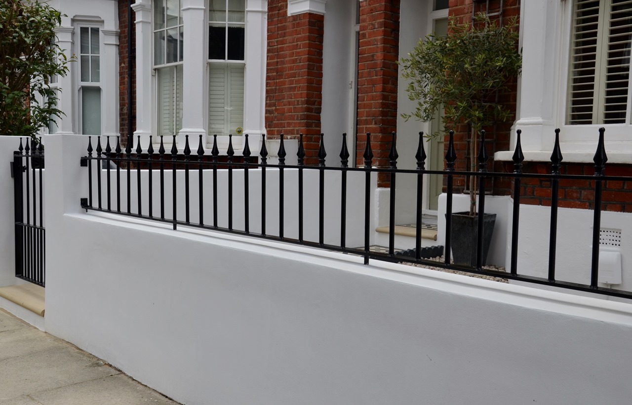 Plastered rendered front garden wall painted white metal wrought iron rail and gate victorian mosaic tile path in black and white scottish pebbles York stone balham london (34)