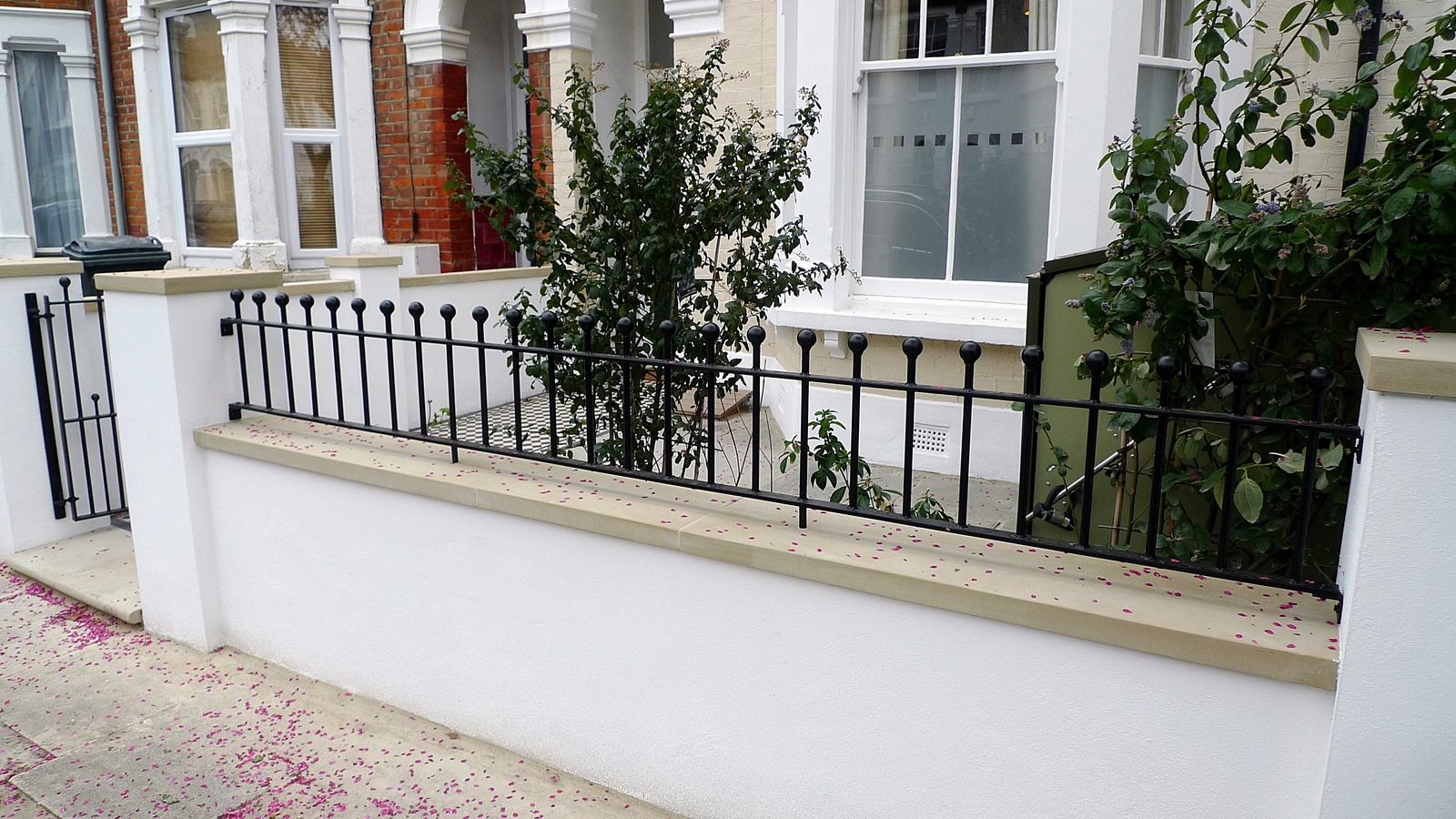 render plaster block wall with yorkstone caps wrought iron rail grey sandstone paving and black and white victorian mosaic tile path balham london (5)