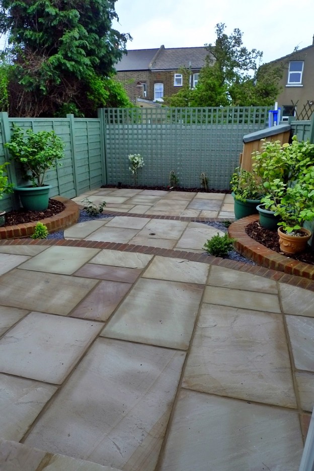 Circles of paving sandstone brick edge raised beds London - London