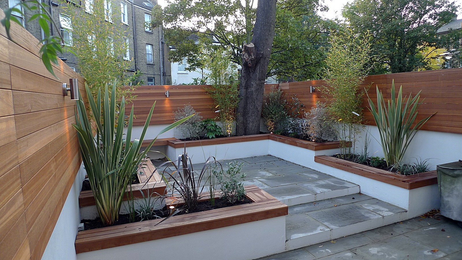 modern london courtyard low maintenance urban outdoor indoor living garden space paving screens planting bench raised beds (9)