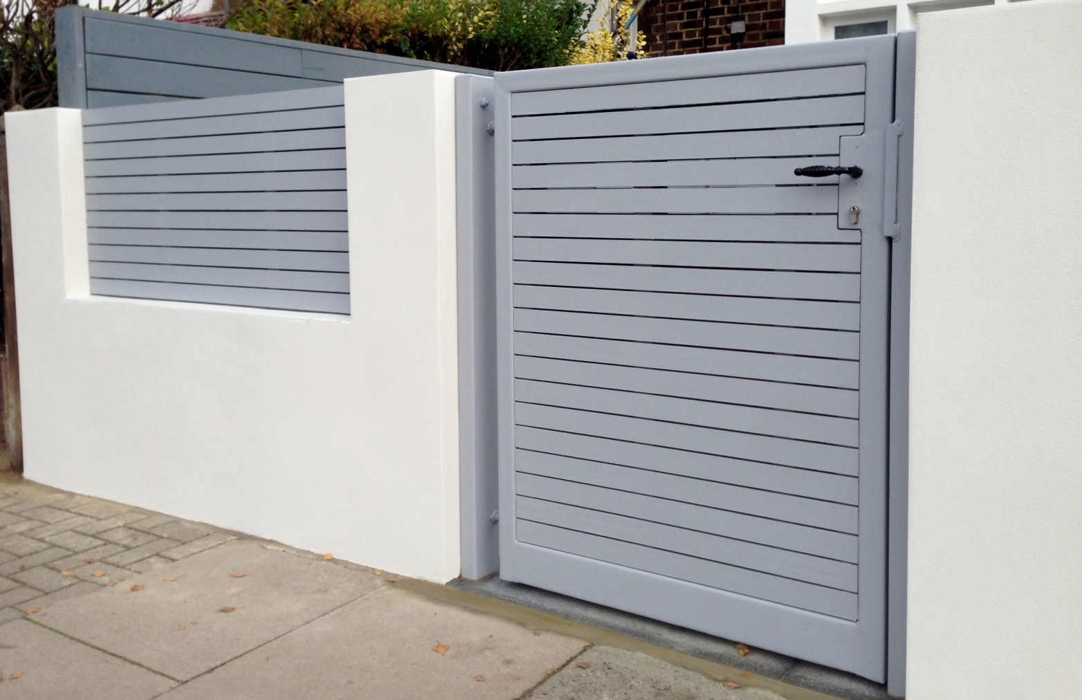 front boundary wall screen automated electronic gate installation grey wooden fence bike store modern garden design balham clapham london (7)