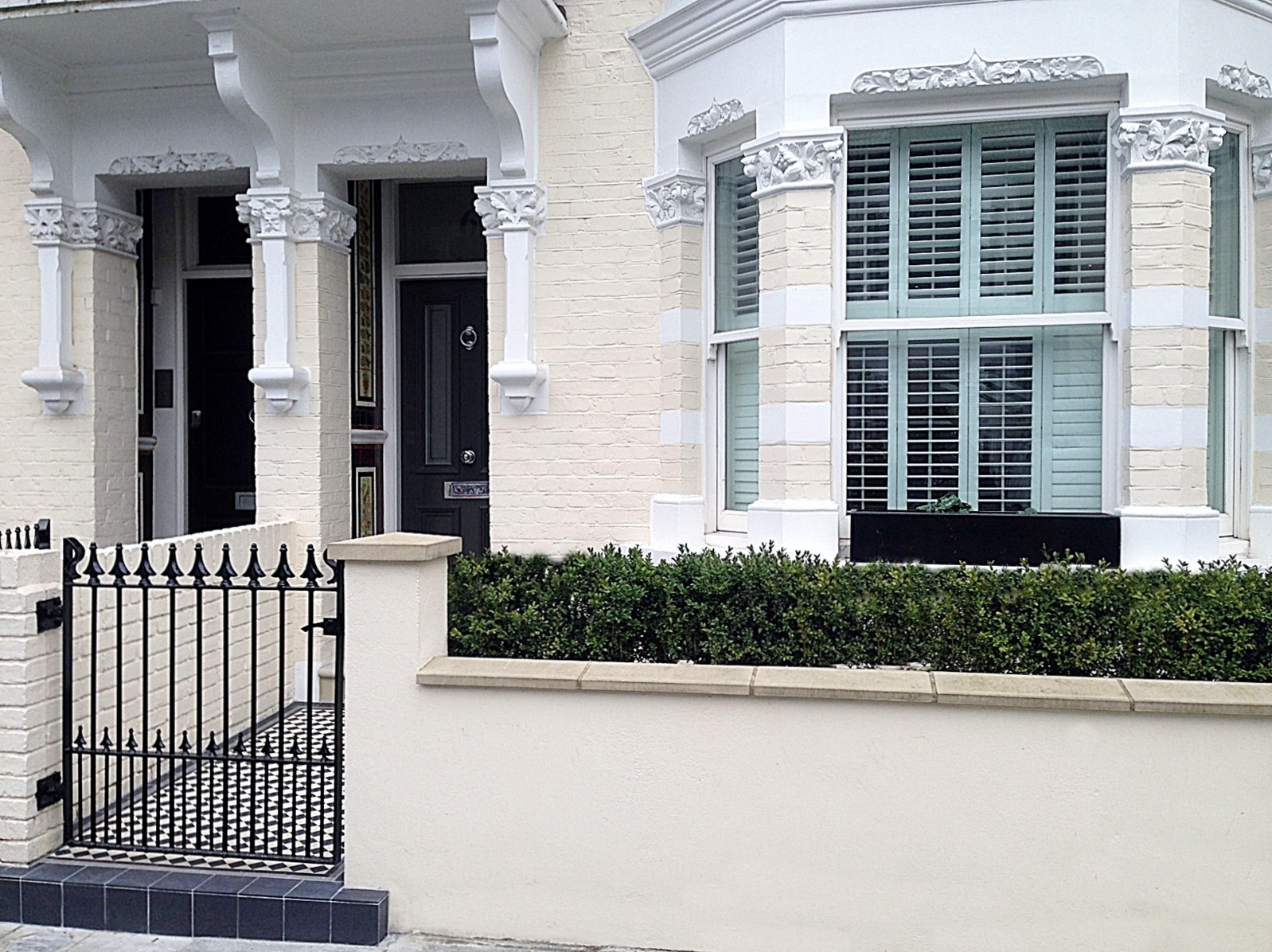 front garden wall and rail victorian moasic tile path black grey and white metal gate and rail fulham chelsea london