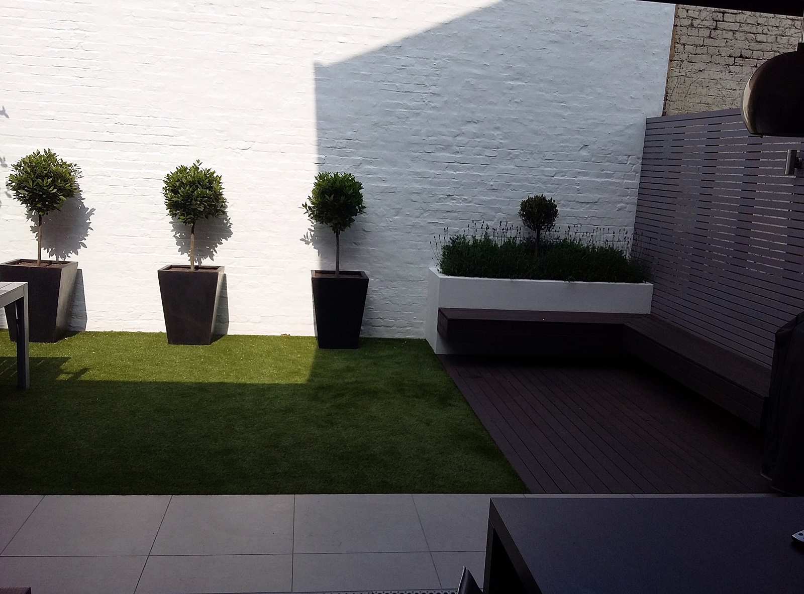 modern courtyard garden design putney wandsworth london artificial grass decking raised beds grey slatted privacy screen trellis