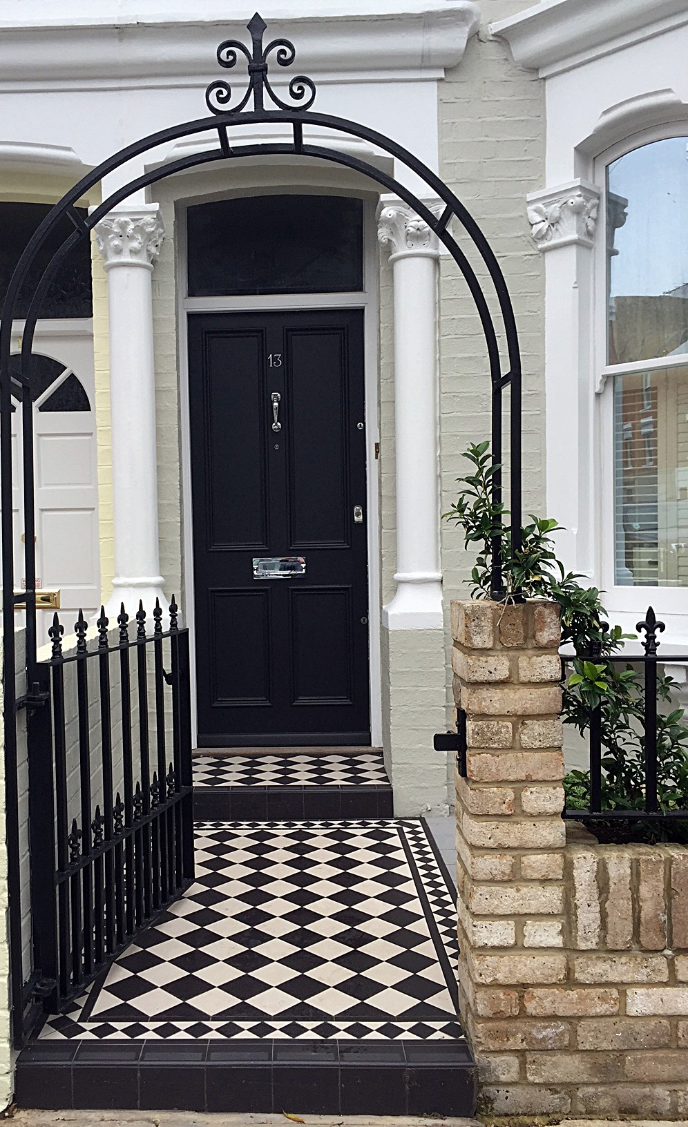 london victorian front garden company black and white chequer board mosaic yellow brick wall metal rail and gate rose arch