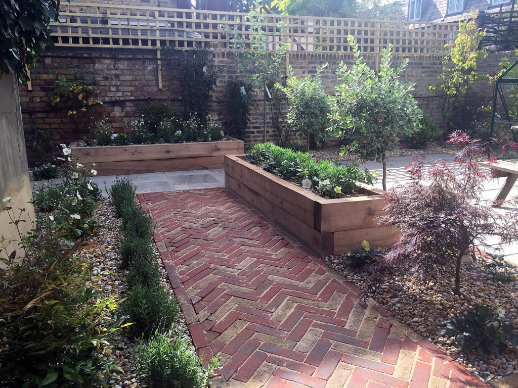 Modern Victorian garden brick walls herring bone brick path oak