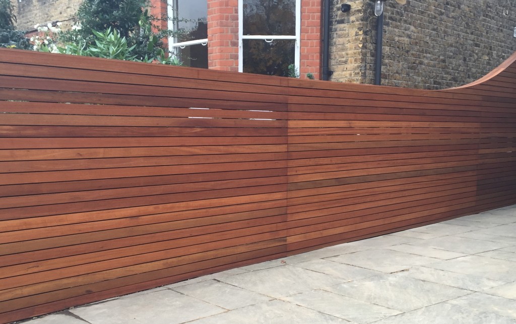 Horizontal cedar hardwood strip wood trellis screen fence oiled curved
