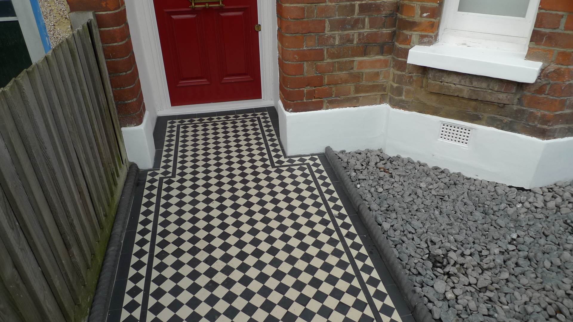 ornamental stone victorian mosaic black and white pebbles white wooden gate Balham Clapham Battersea Dulwich London