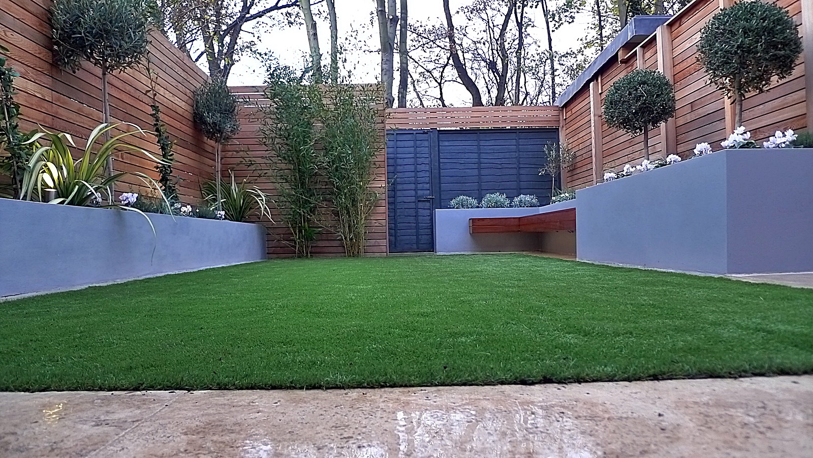 Artificial grass tile grey colour scheme walls fence planting modern design London Streatham Dulwich Clapham