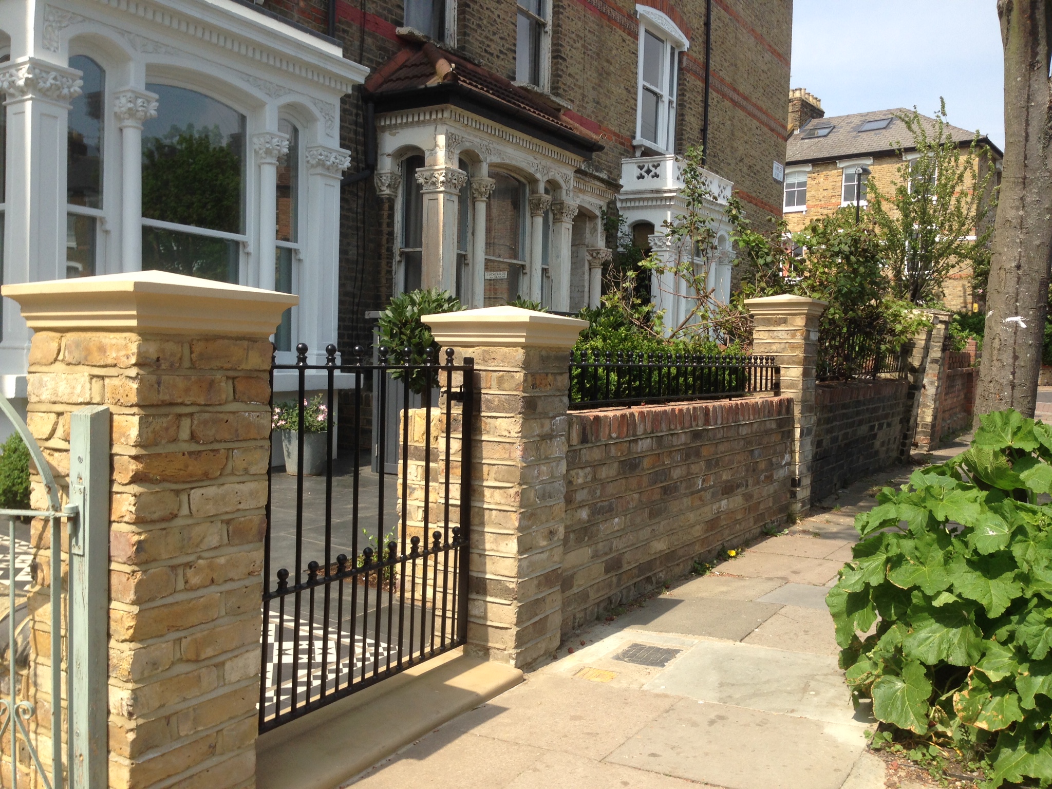 front garden yellow brick wall with buff coping and metal rail and gate clapham islington kensington holland park chelsea fulham london