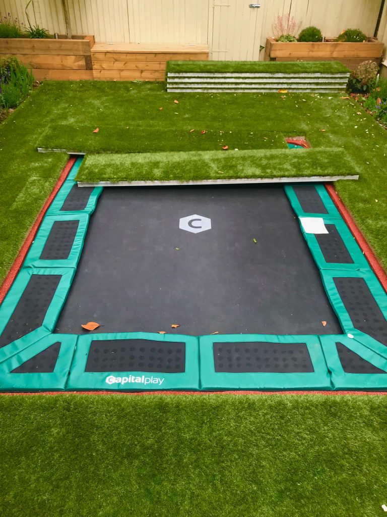 Sunken trampoline with walk on aluminum lid cover artificial grass and