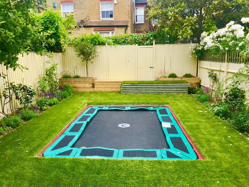 Sunken trampoline with walk on aluminum lid cover artificial grass and