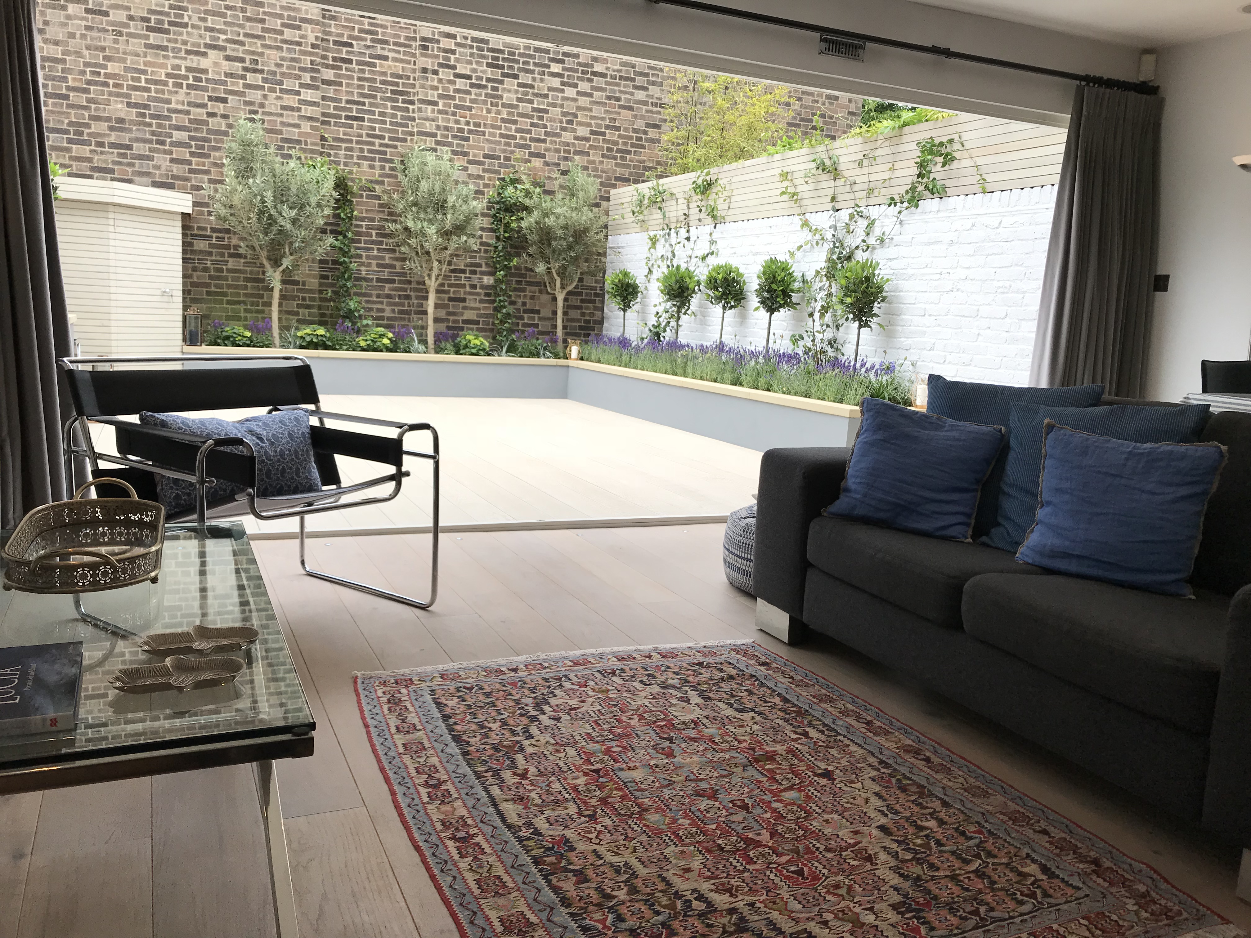 Contemporary modern garden design London decking screen raised bed