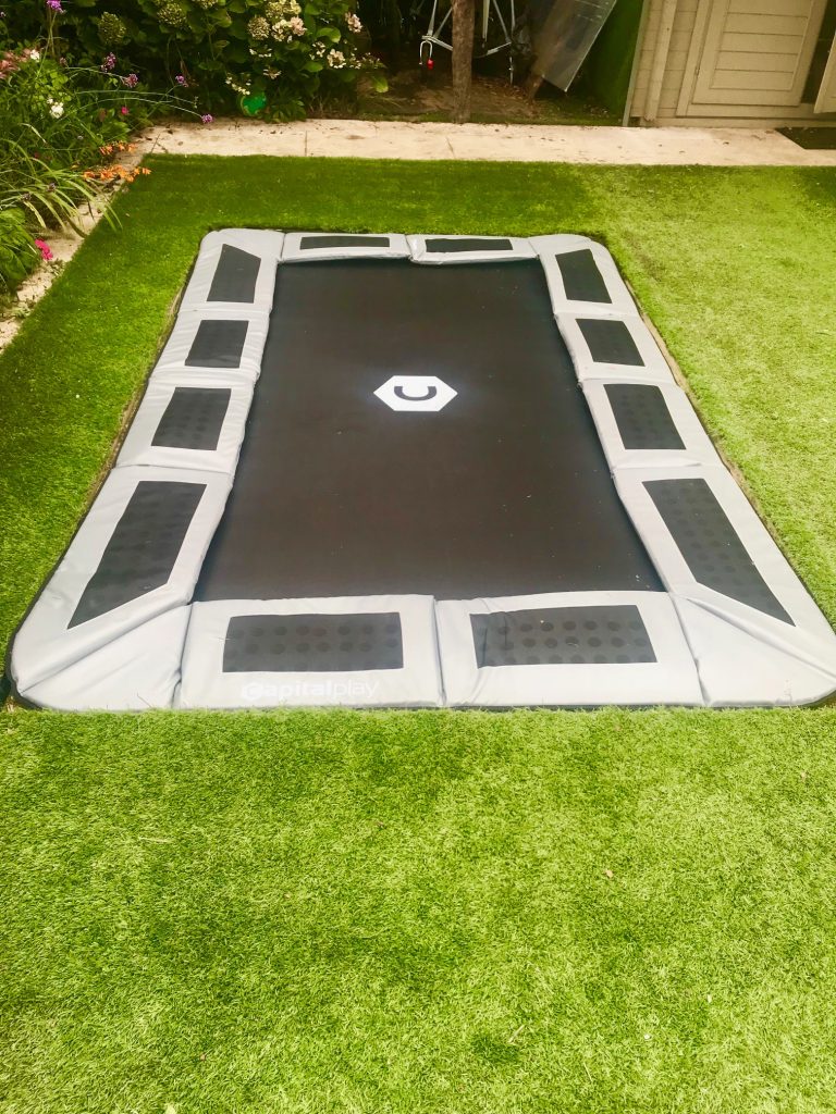 Sunken trampoline with artificial grass and optional lid design and